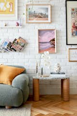 The gallery wall in the living room features a constantly rotating collection of artwork belonging to both Jono and Ryan, combining the couple's individual styles and a colourful and visually dynamic way. The collection also includes pieces from Palette by Jono Fleming, a brand Jono started with his friend, illustrator Rachel Stevens, in the early days of lockdown. The artwork is paired with an ever-rotating display of decorative objects, many of which are found through Jono's work as a stylist.