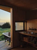 The bathroom is located on an exterior deck but isn’t exposed to the wind or rain thanks to the exterior metal cladding that runs into the bathroom and wraps around the shower. "It keeps the experience of staying there in touch with the elements but not uncomfortable,
