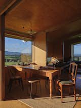 The dining table is generally positioned like a desk at a picture window, but can also be rotated to seat a dinner party. This kind of simple flexibility is built into the hut, which can adapt to sleep up to six guests.
