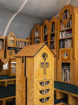 The Architectural Library is furnished with a series of "slide-scrapers," an ad hoc combination of off-the-shelf filing cabinets with painted MDF (medium-density fiberboard) ornamentation designed by Charles himself.