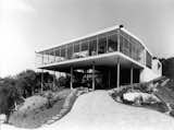 Casa de Vidro when it was recently completed in 1951. The name translates as the Glass House thanks to the glass walls that wrap around the first floor on three sides. Since this photo was taken, the rainforest has regrown around the home, creating a new dialogue between the architecture and the surrounding landscape.  Photo 1 of 15 in Lina Bo Bardi’s Iconic Midcentury in São Paulo Just Reopened With a New Art Exhibition