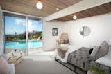 Another bedroom opens directly to the pool area, imbuing the home with casual California vibes.