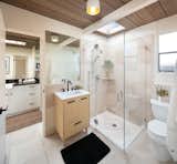 The bathrooms have all been recently refurbished, with a clean natural material palette.  Photo 12 of 14 in This Pristine Eichler in Oakland, California, Just Fetched $2.2 Million