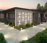 The illuminated diamond pattern (created by double-ended wall lights) is mirrored with alternating Techo-Bloc Industria Triangle pavers in Smooth and Granitex finishes. The resulting walkway—which is also illuminated with minimalist garden lights at its edge—is not only visually stunning, but also highly slip-resistant thanks to the granular texture of the Granitex pavers.