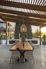 This shaded outdoor dining area, which uses Techo-Bloc’s Borealis slab in Smoked Pine, creates a sophisticated herringbone pattern that extends the elegance of hardwood flooring outside. The timber effect of the concrete slabs is so convincing it’s been called “trompe-l’oeil” by industry professionals. While it has the look and feel of timber, it’s maintenance free—so no staining, rot, or fading.  Photo 15 of 15 in 10 Inspiring Landscaping and Outdoor Design Trends for 2022