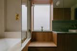 The timber window seat in the family bathroom is a clever detail that makes bathtimes easier for parents. The glass shower screen can swing open to allow access directly from the seat to the bathtub.
