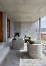 The sea-facing veranda is the ideal spot from which to enjoy panoramic beach views on wind-free days. The bespoke&nbsp;concrete deck chairs, also designed by Pinard Architecture, not only match the aesthetic of the building, but will withstand the often harsh coastal conditions, developing the same kind of patina as the home itself. The rope balustrade was specifically conceived to accommodate wet towels and bathing suits.