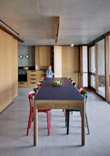 The dining table was designed by architect Guillaume Pienaar to accommodate all 10 family members. It is constructed from hardwood with a Fenix NTM top and paired with APC chairs by Jasper Morrison for Vitra. Both the table and chairs can be moved to other spaces around the home.
