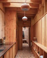The kitchen allows the extension to function completely separately from the main cottage, and it can be separated from the boot room and utility rooms at the private entrance via a sliding timber partition.