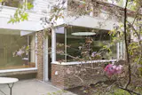 Structurally, the corner of the kitchen is suspended with a slender, exposed 5cm-wide column. This allows for a glass corner instead of masonry/brick pier which keeps the extension feeling light and transparent.