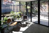 The reading nook was initially supposed to house a small breakfast nook, but it was eventually decided to leave it open with a small reading chair and table. “This little vignette is so perfectly tucked into the curved corner,” says architect Billy Mavropoulos. “It’s such a cozy place to relax and feel enveloped by the garden.”