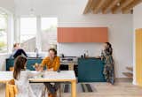 Kitchen, Engineered Quartz Counter, Refrigerator, Pendant Lighting, Light Hardwood Floor, Colorful Cabinet, Track Lighting, Cooktops, and Ceiling Lighting Two Experimental Townhouses Clad in Cor-Ten Steel Add Density to a Seattle Neighborhood - Photo 14 of 19 - 
