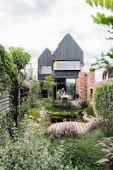 Native gardens and working with existing and reclaimed materials will be big news in 2023, says Godshall. This net-zero passive house in Melbourne features walls built from bricks reclaimed from local construction sites and a native garden with an aquaponic system.