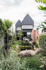 Native gardens and working with existing and reclaimed materials will be big news in 2023, says David. This net-zero passive house in Melbourne is built from upcycled bricks reclaimed from local construction sites and features a native garden with an aquaponic system.  Photo 11 of 15 in Net Zero building by Laura Navarro from The Trends That Will Rule Home Design in 2023