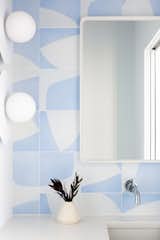The pattern is inlaid into each concrete tile using pigmented clay in a process known as "encaustic" patterning. This creates a durable surface ideal for bathroom floors, kitchen backsplashes, and courtyards.