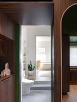 The walk-in-wardrobe connects to the shower / WC room and the bathing room via a pocket door that is concealed within the millwork to allow all the spaces to feel connected.  Photo 10 of 11 in Favorites by Stephanie Walczuk from Before & After: A Toronto Couple Level Up Their Dingy Attic Into a Spa-Like Suite