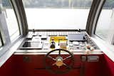 A control panel in front of a large window houses all the technical equipment needed to operate the boat.