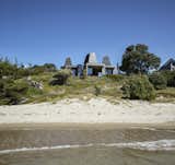"‘With our designs we like embedding a narrative, another level of engagement,’ explains architect Ken Crosson, whose designs often evince a playful or subversive element. It was local gold-mining history that lent its narrative to Light Mine House, a beach bach at Kūaotunu, on the east coast of the Coromandel Peninsula. Nestling among the sand dunes and pīngao, a series of boxes is made unique by the addition of tapering skylights that reach for the sky."  Photo 3 of 10 in 10 New Zealand Homes That’ll Inspire a Trip to the Edge of the Earth