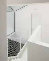 The netted balustrades in the upstairs hallway were inspired by Japanese design. "We wanted to create a lightweight infill of the steel structure, which at the same time would ensure safety,