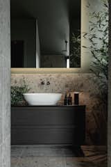 Black timber and a vessel sink complement large-format tiles in the bathroom.