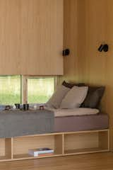 Storage is cleverly concealed beneath the sleeping areas, making the most of the compact floor plan. A row of windows alongside the bed connects inhabitants to the natural surroundings.  Photo 3 of 103 in Favorites by Rick Hendricks from This Kitchen Maker Is Upcycling Offcuts to Create $59K Tiny Cabins