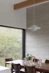 The glazing is arranged to allow sunlight in, and opens in summer to passively cool the home, requiring little active energy in use.