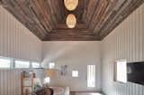 With raw barn boards on the ceiling and a casual arrangement of beds and bunks, the "bunkie" has more of a cottage feeling than the main building.&nbsp;