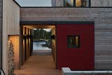 The breezeway—playfully called the Monocular—separates the two buildings, links the outdoors with indoors, and provides a portal to the impressive water view. It can be closed off for security with a large, barn-style red door.&nbsp;