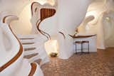 Architect Charles Harker spent seven months on site carving the organic forms from polyurethane foam which was then coated in white stucco. According to Harker, the carved wood is meant to emulate bones sticking out of skin.