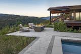 The sprawling Californian landscape and the wildness of the surrounding vegetation is perfectly offset by the geometric pattern of the tiles in shades of gray. The main patio is tiled using Techo-Bloc Diamond pavers in contrasting Smooth and Granitex textures, with a border of rectilinear Para slab and Raffinato cap around the pool. The Greyed Nickel color visually unites the variety of shapes to create a refined finish—add comfy chairs and a firepit and you’ve got a dreamy spot to watch the sunset.  Photo 9 of 10 in These 10 Trends Will Define Outdoor Design in 2023