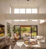 The living area leads out to the back garden through large glazed doors, framing a view that changes with the seasons. Interior and landscape designer Jennifer Runkle has created a refined interior scheme that offers an elegant backdrop to the vibrant outlook.
