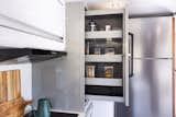 The pantry slides out to offer easy access to shelving.