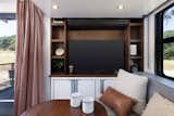 The 42” 4K TV with media center shelving feels more like a feature found in a high-end apartment than a conventional RV.  Photo 9 of 14 in This $300K Off-Grid Travel Trailer Even Comes With a Walk-In Closet