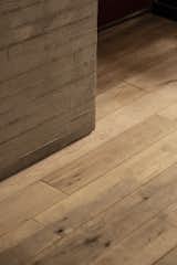 The board-form concrete of the kitchen island complements the timber flooring.