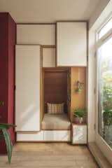 The reading nook is surrounded by storage designed to accommodate specific items. The tall cupboard, for example, houses an ironing board and ladder. "The shapes are not just arbitrary,
