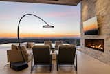 Due to the soaring ceilings over the patio that open it up to the views—including impressive sunsets—heating the covered outdoor space was a challenge. The solution was found in the freestanding Bromic Eclipse Portable heater.  Photo 3 of 11 in This Arizona Home Uses the Desert Landscape as “Living Art”