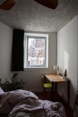 <span style="font-family: Theinhardt, -apple-system, BlinkMacSystemFont, &quot;Segoe UI&quot;, Roboto, Oxygen-Sans, Ubuntu, Cantarell, &quot;Helvetica Neue&quot;, sans-serif;">The cozy guest bedroom—which is rented out through Airbnb—boasts impressive views over the surrounding architecture of </span><span style="font-family: Theinhardt, -apple-system, BlinkMacSystemFont, &quot;Segoe UI&quot;, Roboto, Oxygen-Sans, Ubuntu, Cantarell, &quot;Helvetica Neue&quot;, sans-serif;">Orgues de Flandre.</span>  Photo 2 of 11 in Budget Breakdown: $91K and Vintage Flair Revive a Flat in One of Paris’s Coolest Buildings
