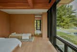 The primary suite, with custom oak casework, offers views to the south and east.  Photo 15 of 17 in This Vacation Home in Rural Ontario Sets a New Standard for Prefab Architecture