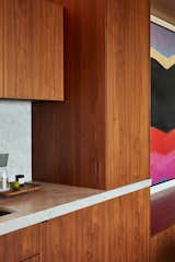 The bar can be completely concealed within the walnut casework when not in use.