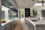 The kitchen features a glass window backsplash that invites abundant light into the interior.