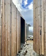 The exterior cladding is thermally stabilised pine from Finnish company LunaWood. “It works beautifully with our climate and the harsh UV,” says architect Leon van der Westhuizen.  Photo 7 of 16 in Budget Breakdown: This Remote Prefab Hideaway Built From Shipping Containers Cost $300K