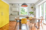 The interior is mostly painted white with vibrant pops of color adding a distinctive Bauhaus touch. In the kitchen, this is expressed through the mustard yellow cabinetry. "I really love Bauhaus and Mid-Century tones,