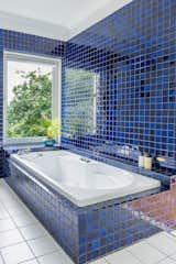 <span style="font-family: Theinhardt, -apple-system, BlinkMacSystemFont, &quot;Segoe UI&quot;, Roboto, Oxygen-Sans, Ubuntu, Cantarell, &quot;Helvetica Neue&quot;, sans-serif;">The blue tiles and Jacuzzi bath were a 1980's addition to the home. Catherine and Dermot loved them, and so renovated the entire bathroom around the bathtub and tiles. "We just didn't think there was any point in changing something we liked so much,