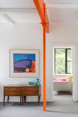 <span style="font-family: Theinhardt, -apple-system, BlinkMacSystemFont, &quot;Segoe UI&quot;, Roboto, Oxygen-Sans, Ubuntu, Cantarell, &quot;Helvetica Neue&quot;, sans-serif;">The penthouse is defined by splashes of bright orange. "We exposed this structural element that had been buried in a partition wall and decided to paint it bright orange,