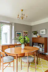 The dining area is made up of Mid-Century furniture that the couple has collected over the years.