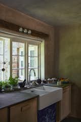 The countertops and hearthstones are crafted from upcycled slate from old snooker tables that were sourced by Miriam.