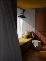 The light above the daybed is the Lampe de Marseille—a sculptural wall light designed by Le Corbusier for the Unité d'Habitation in Marseille at the turn of the 1950s and reissued by Nemo Lighting. The BZippy concrete side table is from Australian design brand Criteria Collection.