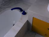 As the marble slabs surrounding the bath were retained from the original fit-out, it was impossible to change the tapware—which was a shiny chrome and felt dated. To give it new life and a more contemporary style, Prineas had it powdercoated in the same bold blue color as the new tapware.