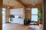The kitchen is made from standard IKEA cabinets, paired with a custom stainless steel benchtop and splashback fabricated for just $650. “No tiles, no grout, no junctions—it’s one continuous piece,” says Lev.