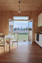 Simple French doors open to the backyard, extending the living area outside.